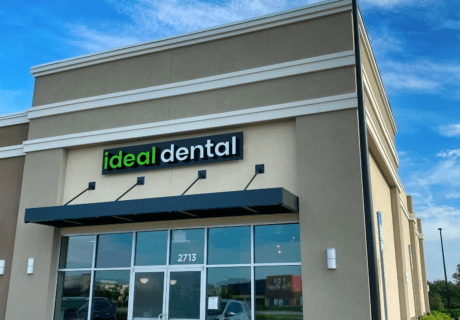 The front exterior of Ideal Dental in Osceola County showing the black awning and Ideal Dental signage.