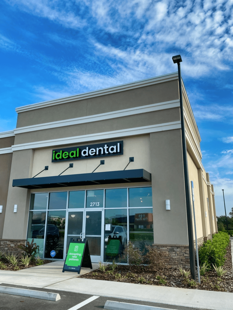 The front exterior of Ideal Dental in Osceola County showing the black awning and Ideal Dental signage.